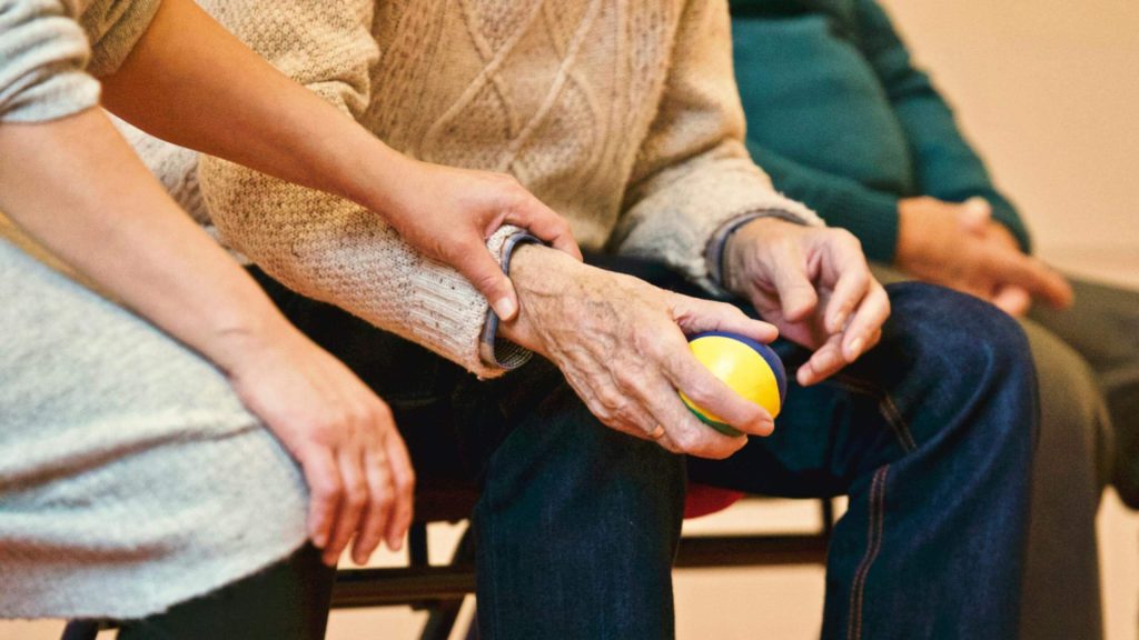 Seniors holding hands and holding a ball